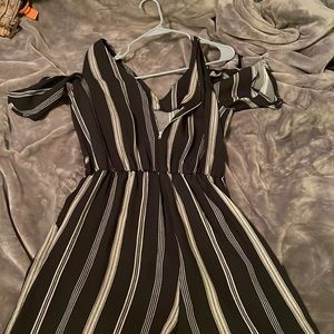 Black and grey striped one piece with peek a boo sleeves. Size large